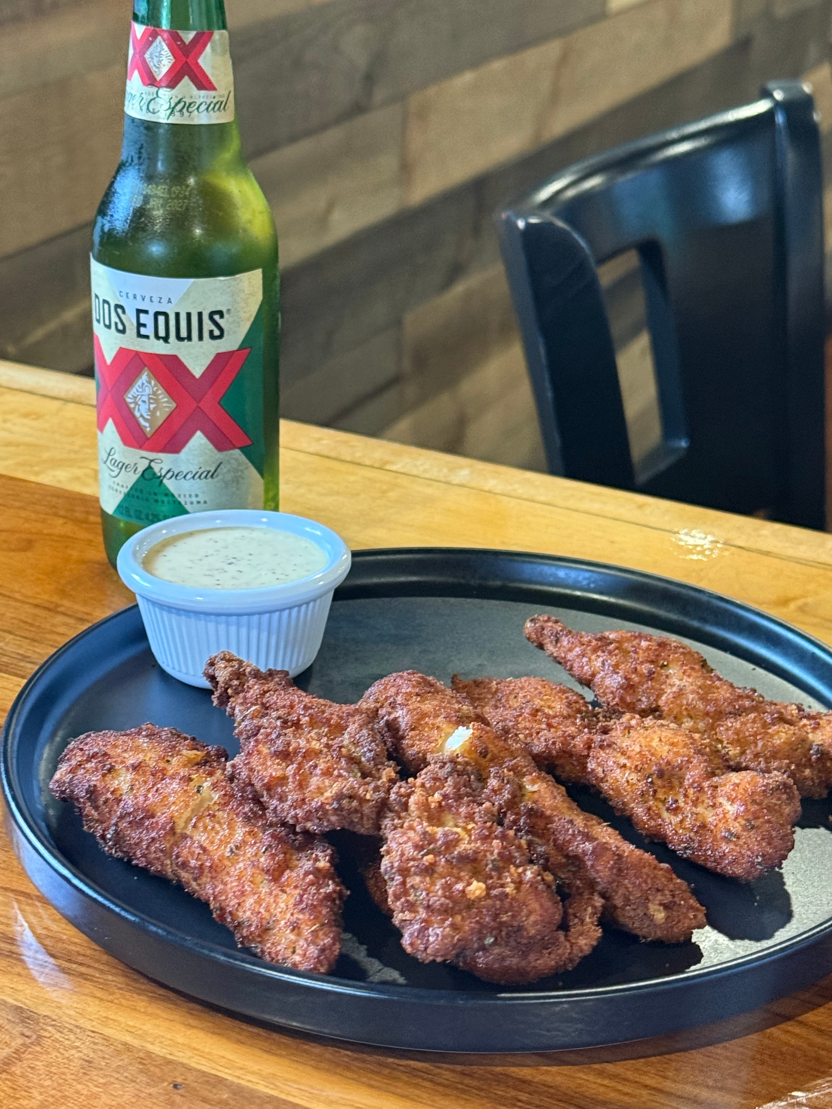 Crispy chicken wings with an ice-cold beer at Woody's Parkway Pub, Everett MA